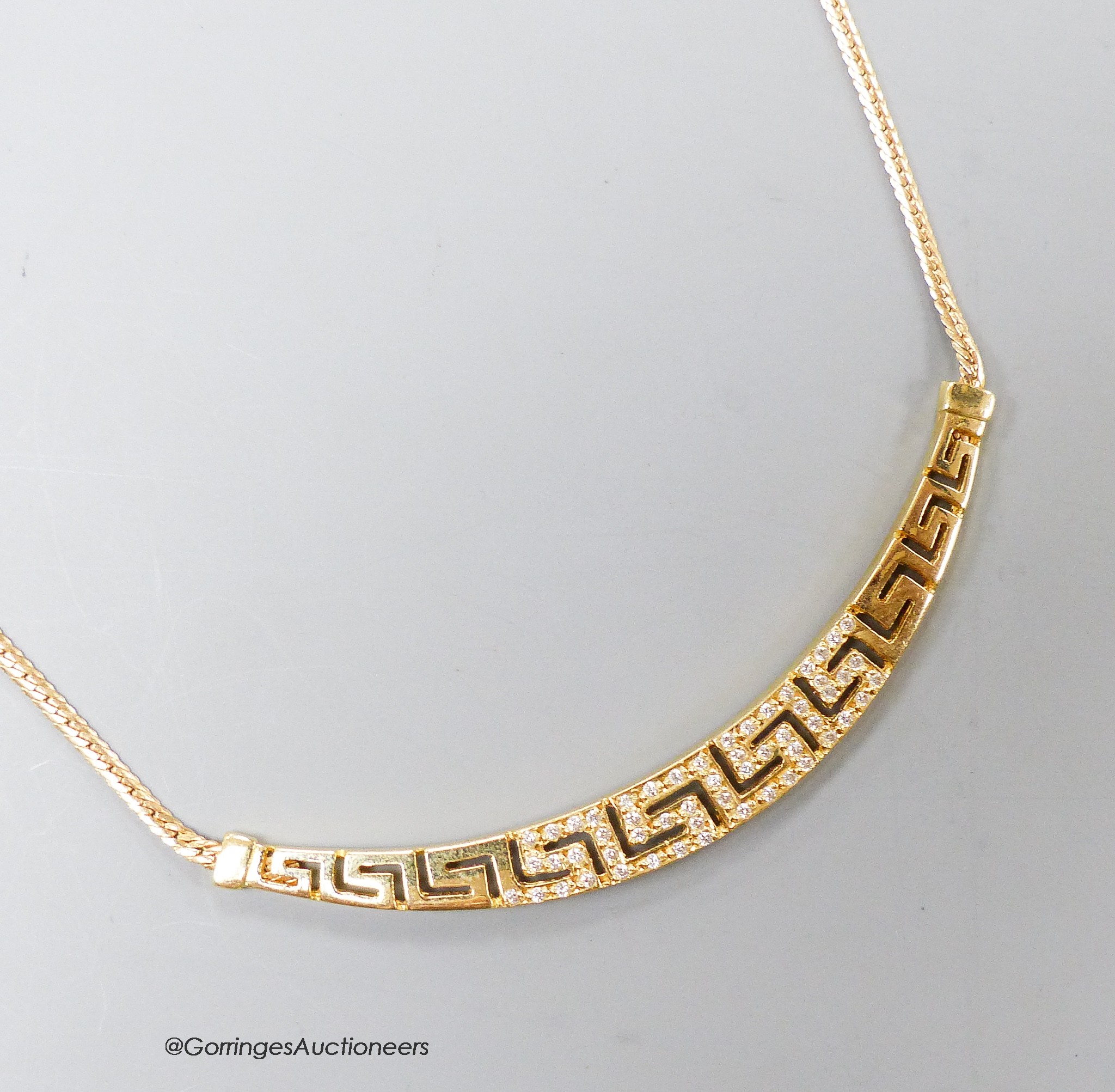 A modern 585 yellow metal and white stone set 'Greek key' pattern necklace, approx. 40cm, gross 8.2 grams.